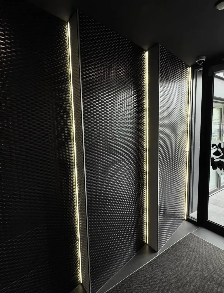 Vertical LED strip lighting on a textured feature wall in a Melbourne building entrance, by Accorto Electrical