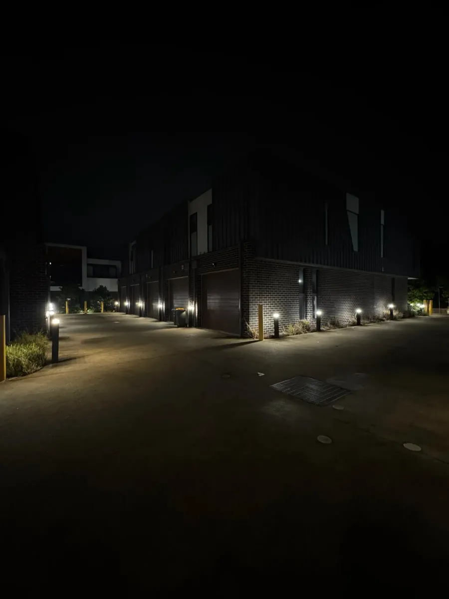 Townhouse complex at night lit with bollard and wall lighting by Accorto Electrical