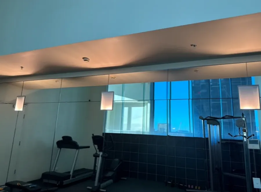High-rise gym with feature wall lighting and city views, fitted out by Accorto Electrical
