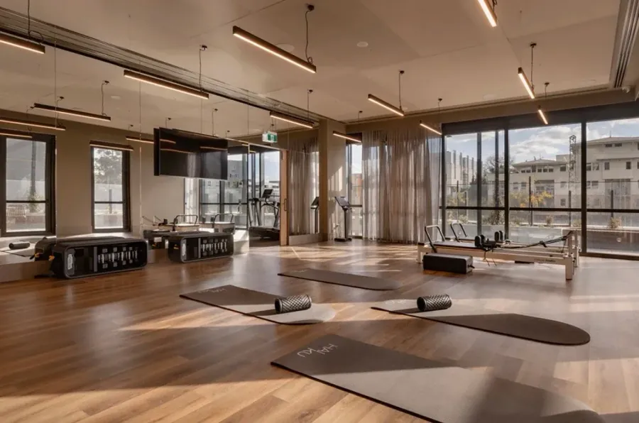 Bright Melbourne pilates studio with linear pendant lighting installed by Accorto Electrical